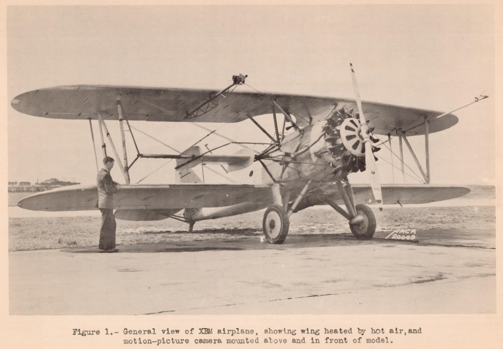 Figure 1. General view of XBM airplane, showing wing heated by hot air, and motion-picture camera mounted above and in front of model.